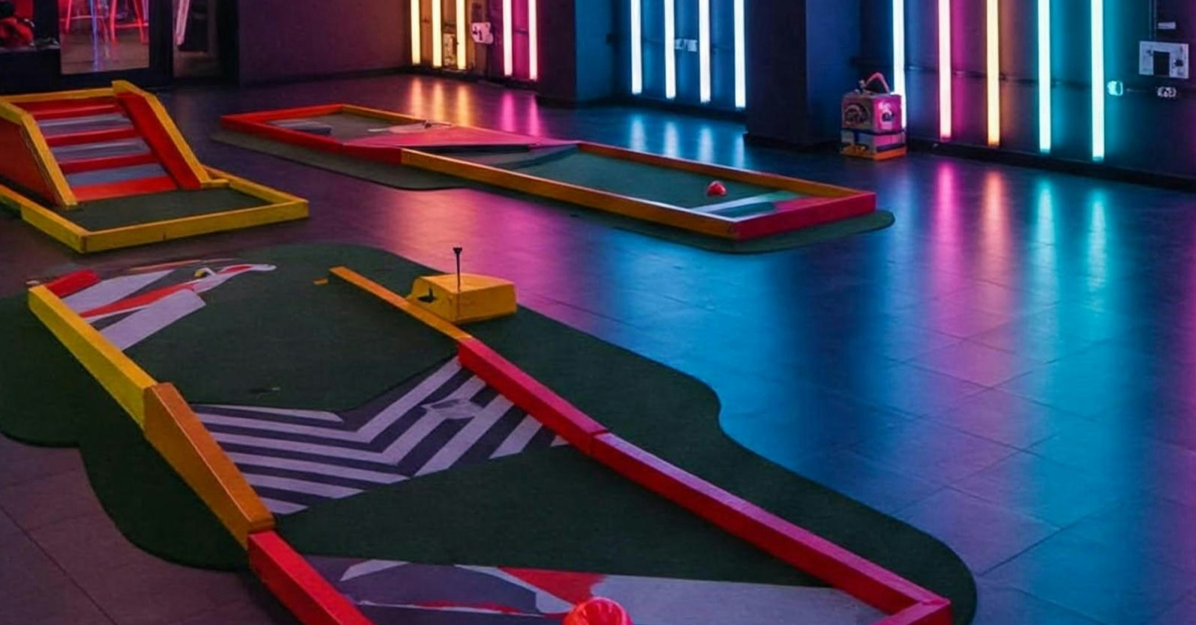 Indoor neon mini-golf venue
